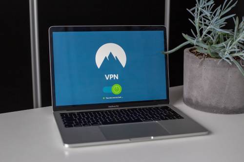 Laptop sitting on a desk with a blue screen